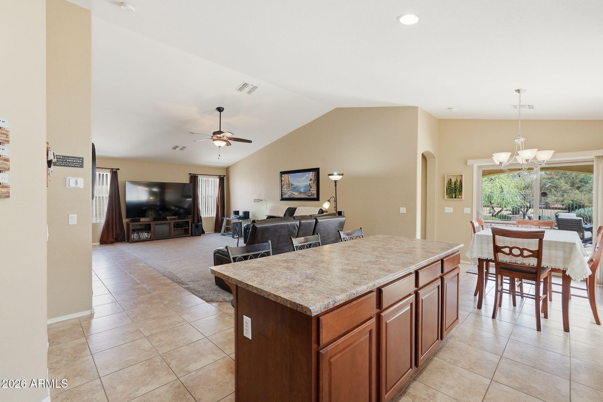 2936 East Crescent Way Gilbert, AZ 85298 - Photo 17 of 40 a kitchen with a stove a refrigerator and a dining table with the kitchen island