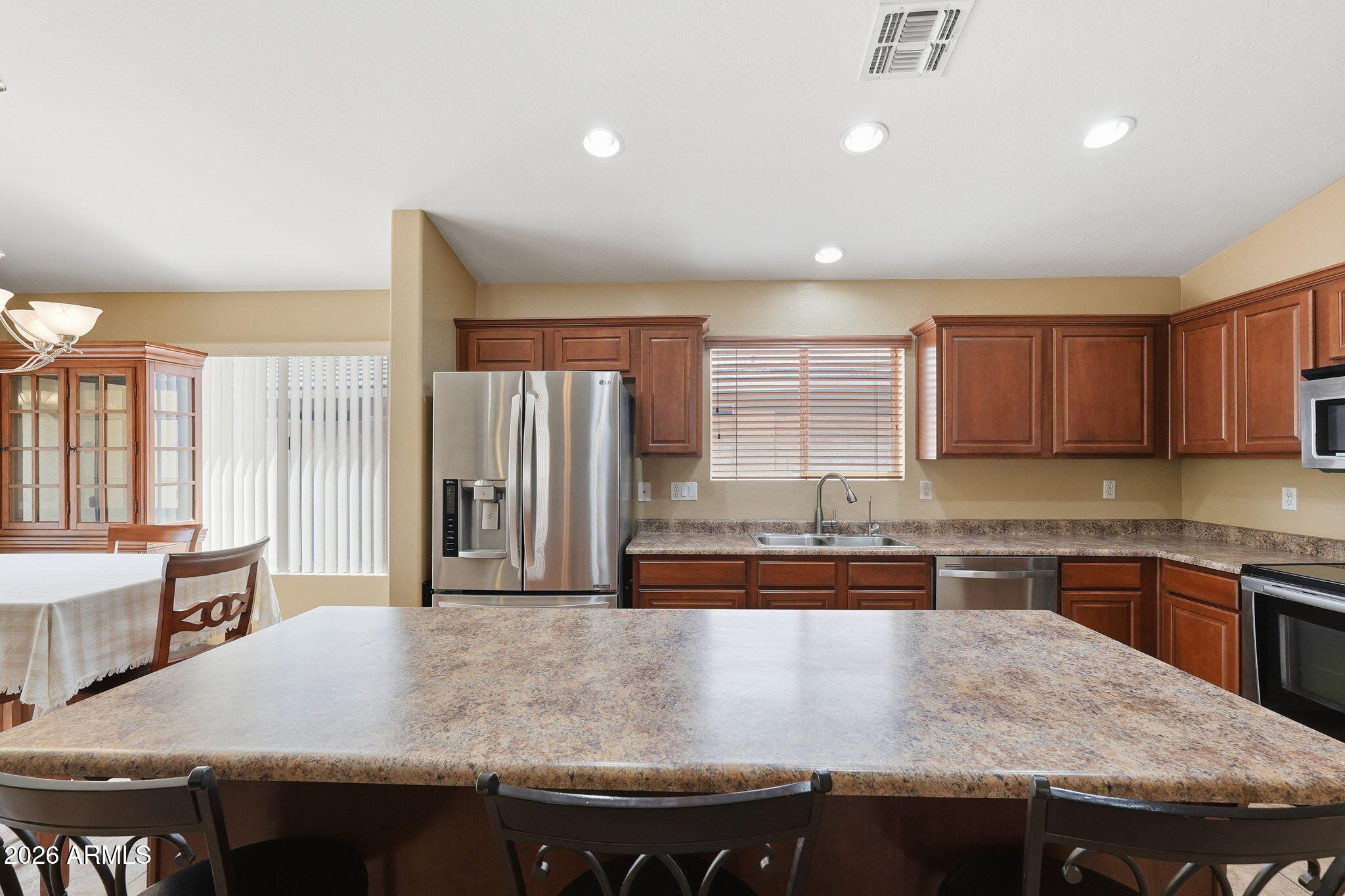 2936 East Crescent Way Gilbert, AZ 85298 - Photo 18 of 40 a kitchen with stainless steel appliances granite countertop a sink and a stove