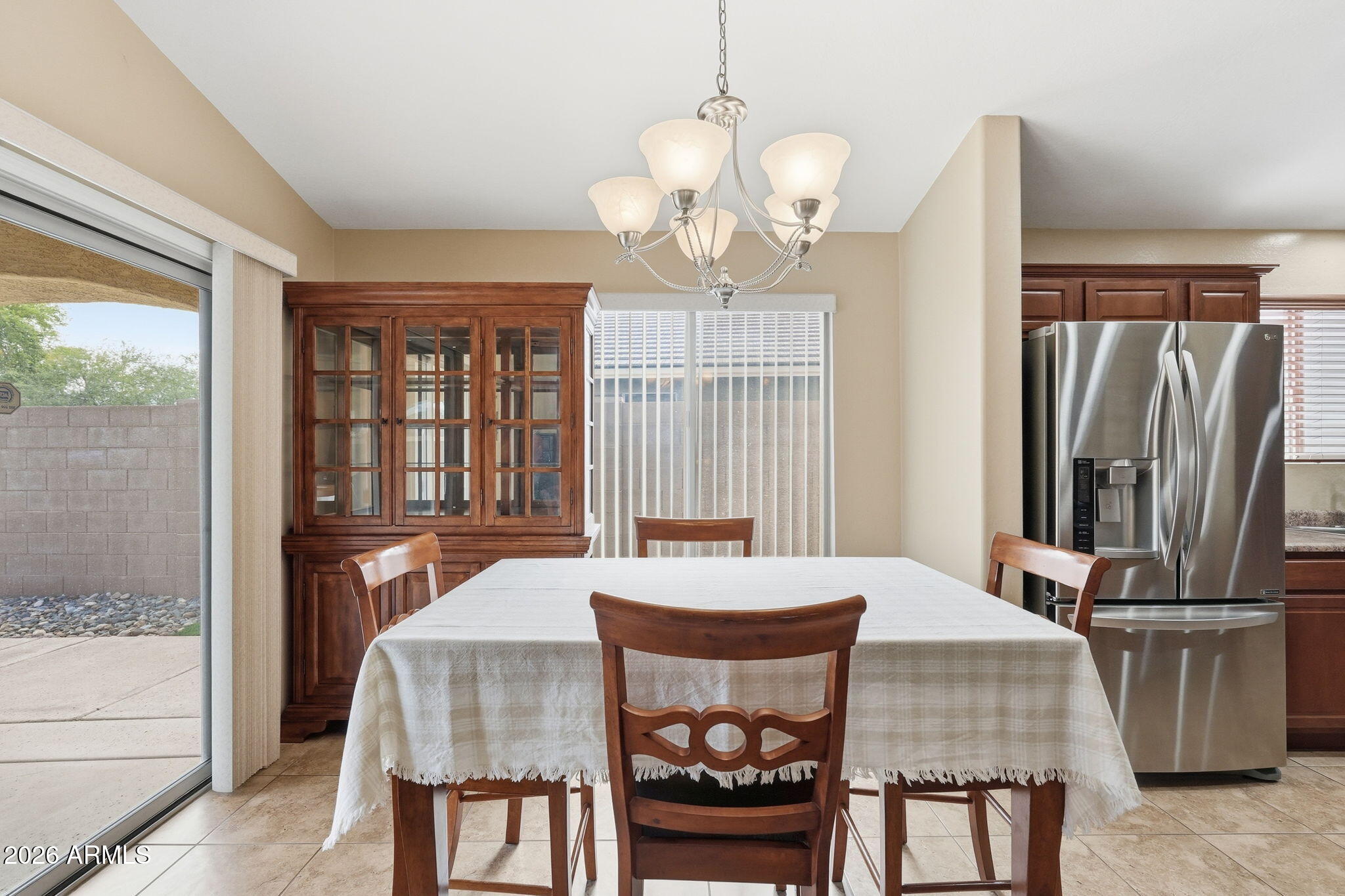 2936 East Crescent Way Gilbert, AZ 85298 - Photo 23 of 40 a dining room with wooden floor a chandelier a wooden table and chairs