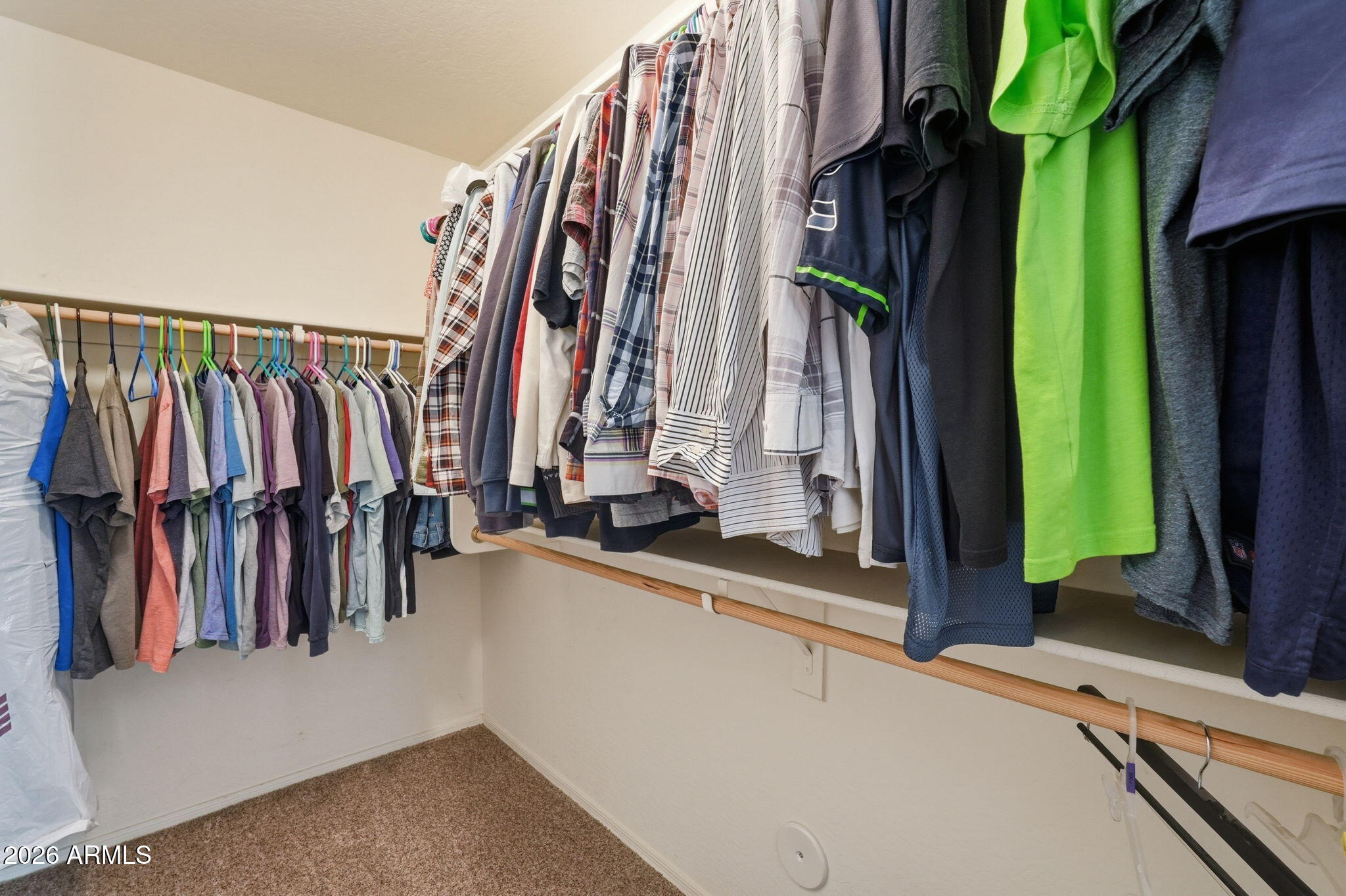2936 East Crescent Way Gilbert, AZ 85298 - Photo 33 of 40 a view of walk in closet with clothes and shoes