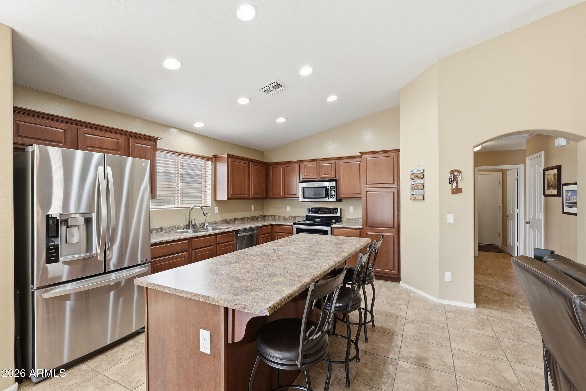 2936 East Crescent Way Gilbert, AZ 85298 - Photo 3 of 40 a kitchen with stainless steel appliances granite countertop a refrigerator and a stove top oven