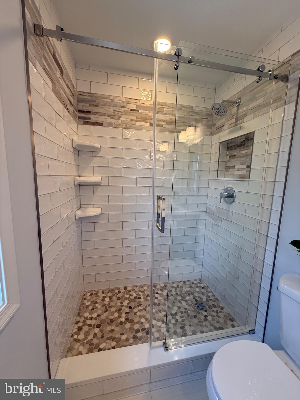 192 Hickory Point Road Pasadena, MD 21122 - Photo 19 of 53 Sleek glass shower with modern tiles.
