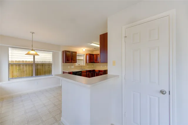 a kitchen with stainless steel appliances a sink and a large window