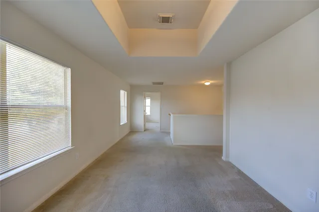 a view of a hallway with windows