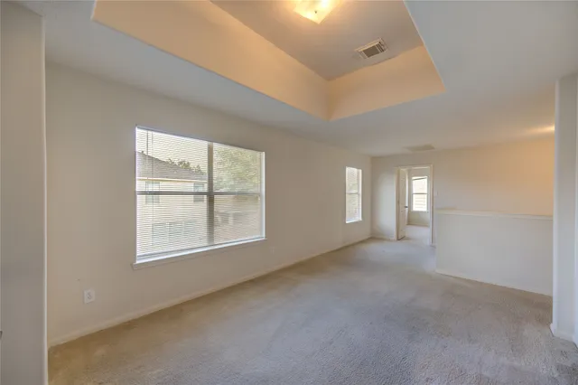 an empty room with windows and closet