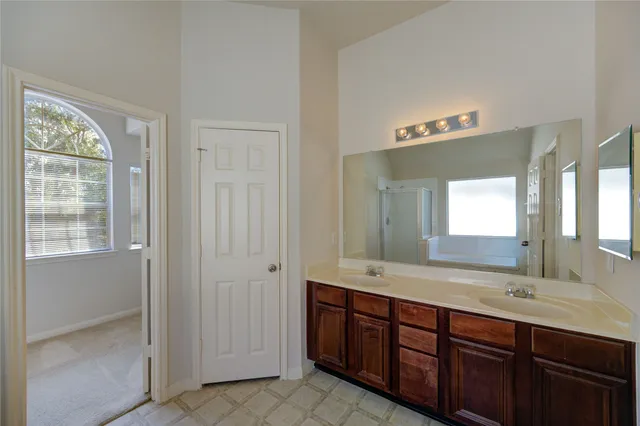 a bathroom with a double vanity sink and a mirror