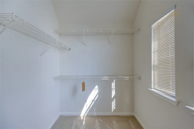 an empty room with wooden floor a mirror