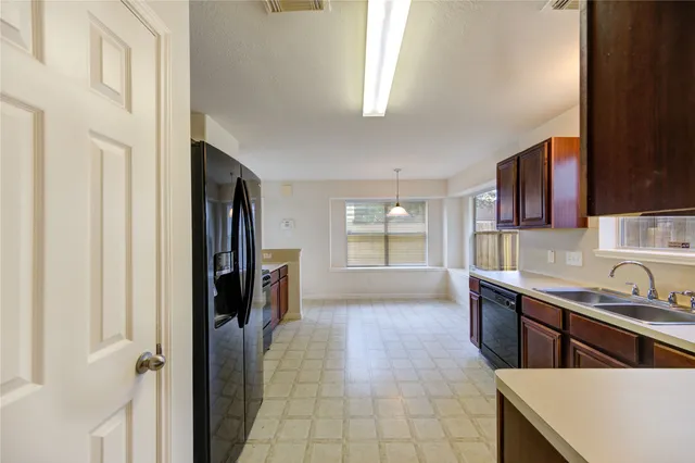 a kitchen with stainless steel appliances a sink stove and cabinets