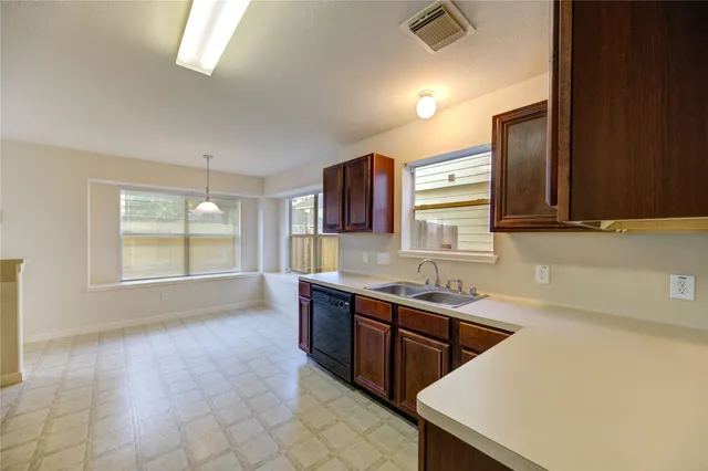 a kitchen with stainless steel appliances a sink stove and cabinets