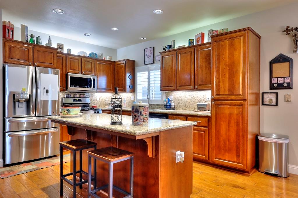 4152 Post Oak Drive Turlock, CA 95382 - Photo 26 of 71 a kitchen with stainless steel appliances granite countertop a refrigerator a stove top oven a sink and dishwasher