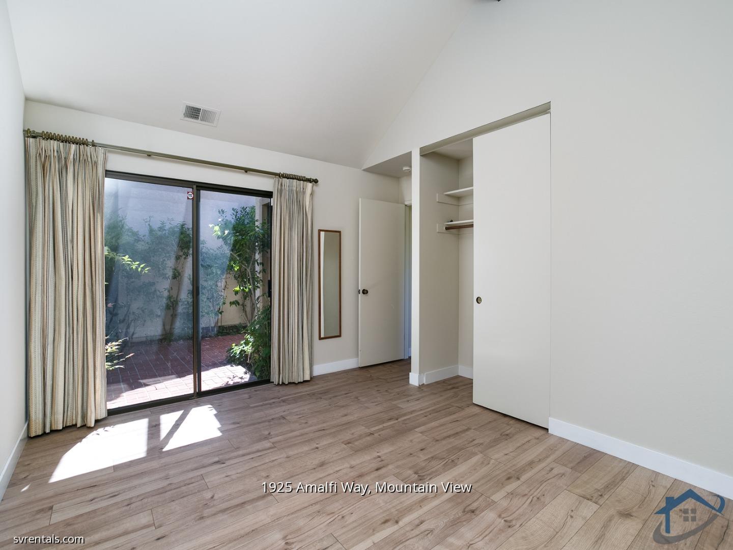 1925 Amalfi Way Mountain View, CA 94040 - Photo 13 of 23 an empty room with wooden floor and windows