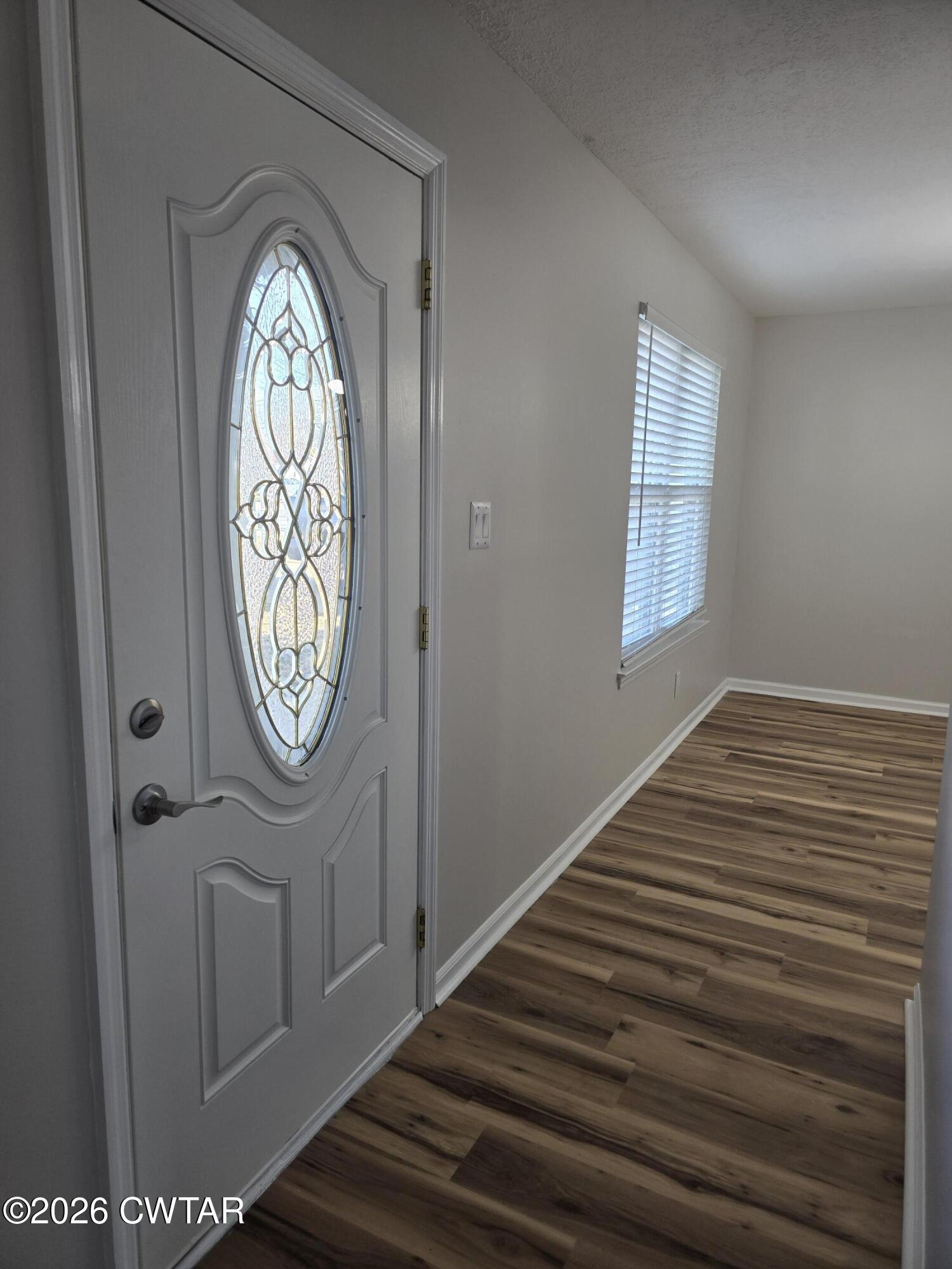157 Dustin Drive Jackson, TN 38301 - Photo 2 of 22 a view of a hallway with wooden floor