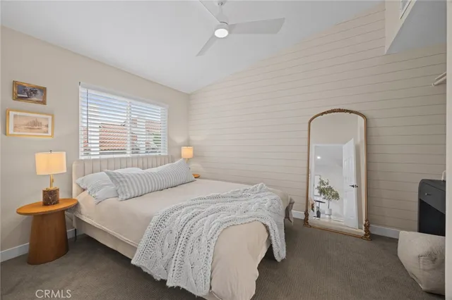 a bedroom with a bed and a mirror