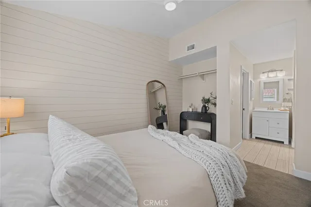 a bedroom with a bed and a lamp