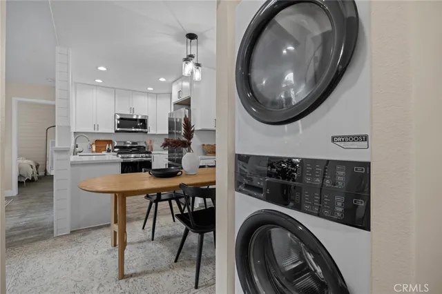 a kitchen with stainless steel appliances a stove a microwave and a refrigerator with wooden floor