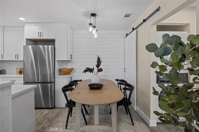 a kitchen with refrigerator and microwave