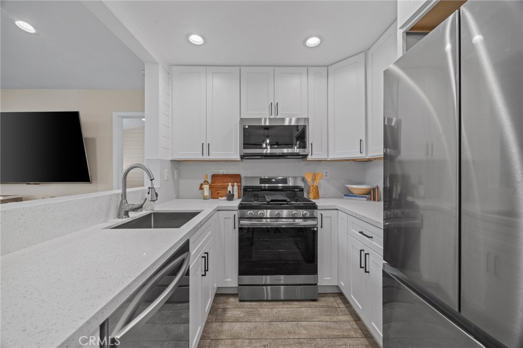 7 Rosa Rancho Santa Margarita, CA 92688 - Photo 6 of 22 a kitchen with stainless steel appliances granite countertop a stove a sink and a refrigerator