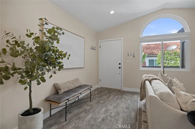 a living room with furniture and a potted plant