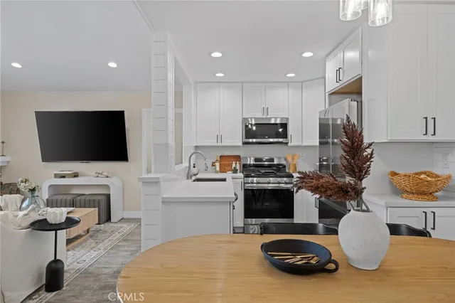 a kitchen with microwave a stove and cabinets