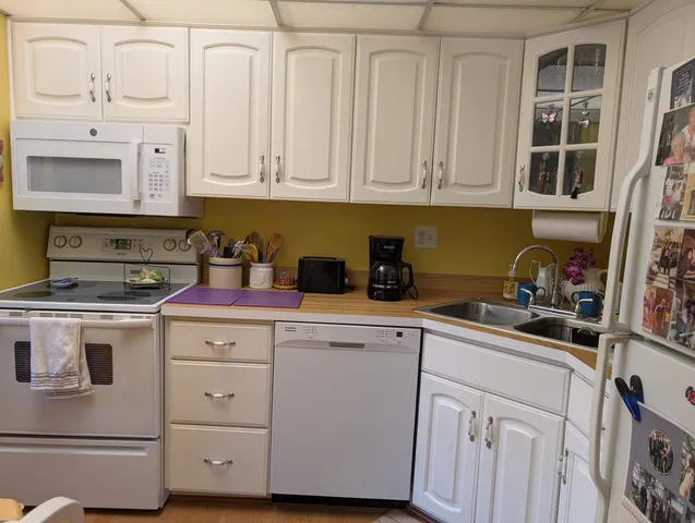 a kitchen with stainless steel appliances a stove a sink a refrigerator and cabinets