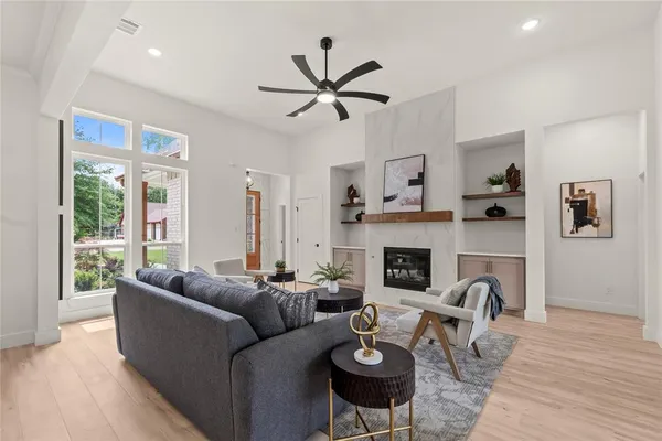 a living room with furniture and kitchen view