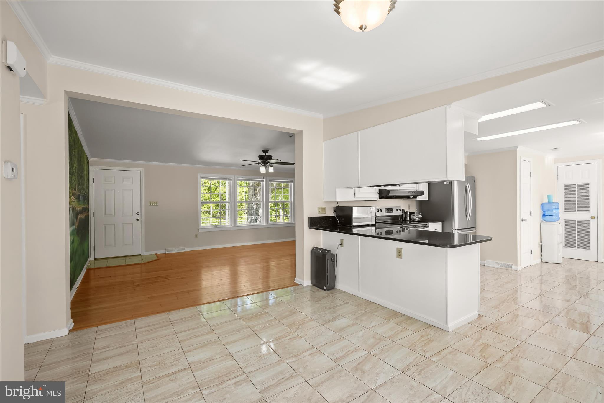 3325 Allday Road Huntingtown, MD 20639 - Photo 14 of 77 a kitchen with stainless steel appliances kitchen island granite countertop a refrigerator and a stove top oven