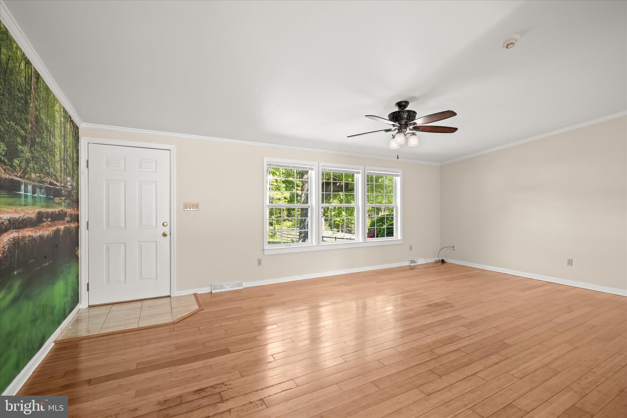 3325 Allday Road Huntingtown, MD 20639 - Photo 9 of 77 a view of an empty room with a window and wooden floor