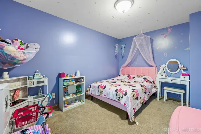 a bedroom with a bed and a dresser in it