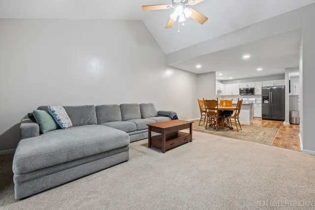 a living room with furniture and a chandelier