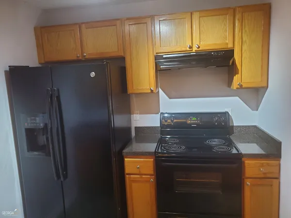 a kitchen with granite countertop cabinets and stainless steel appliances