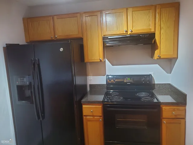 a kitchen with granite countertop cabinets and stainless steel appliances