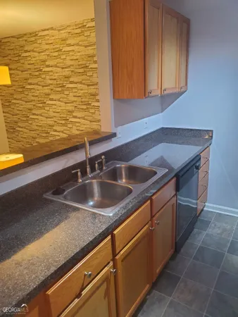 a kitchen with sink and cabinets
