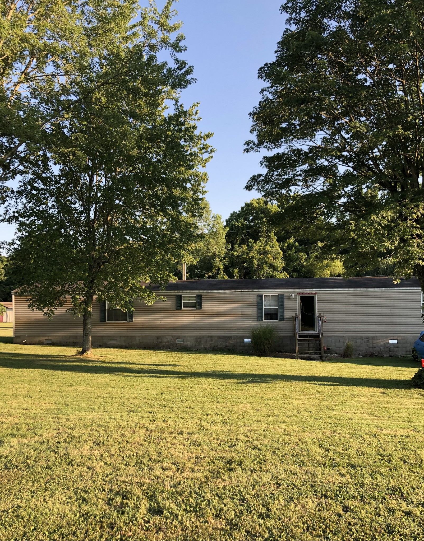 410 Fort Blount Road Hartsville, TN 37074 - Photo 1 of 8 a view of a swimming pool with an outdoor seating and a forest