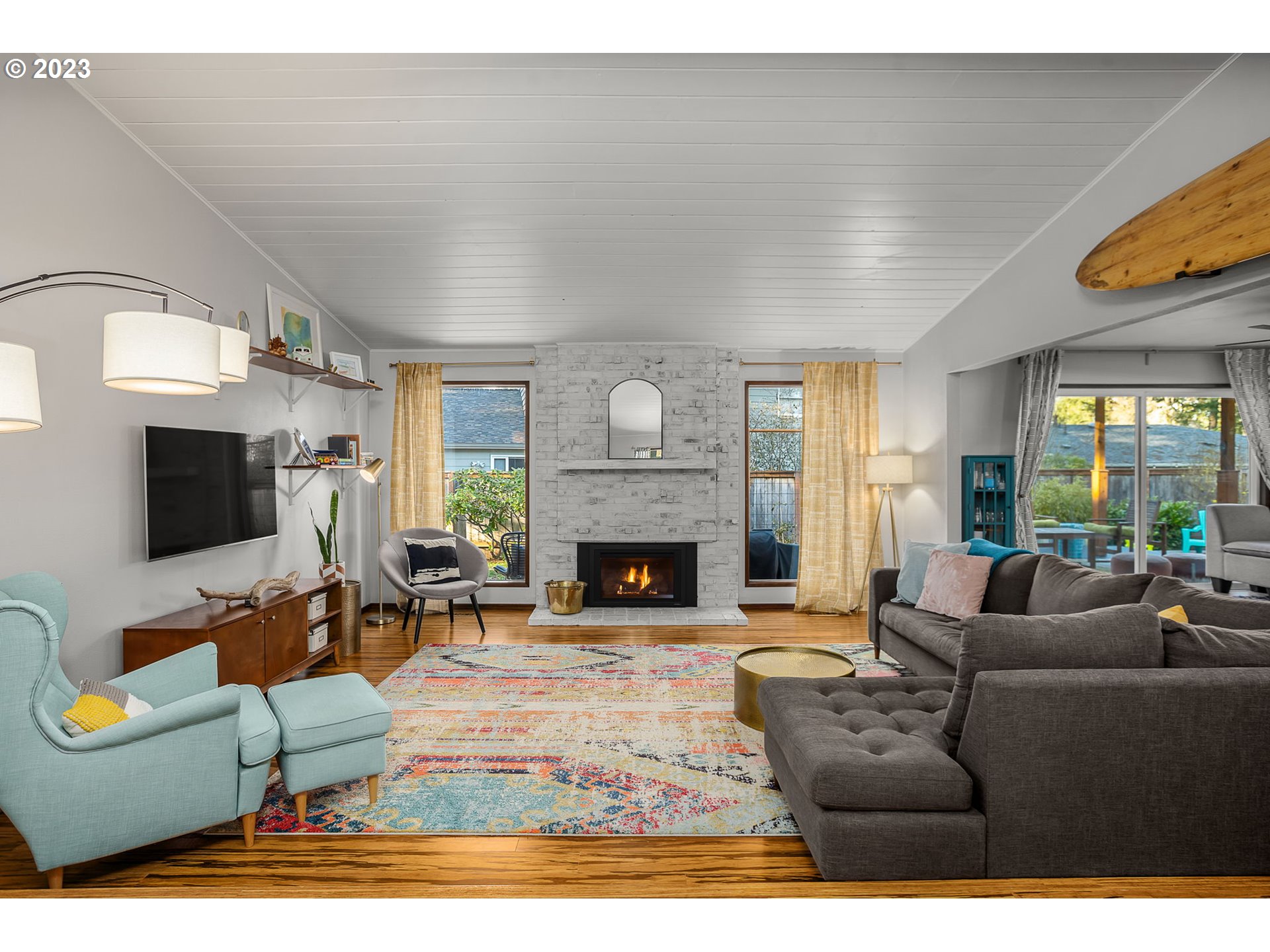14155 Southwest Hart Road Beaverton, OR 97008 - Photo 23 of 30 a living room with furniture a fireplace and a flat screen tv