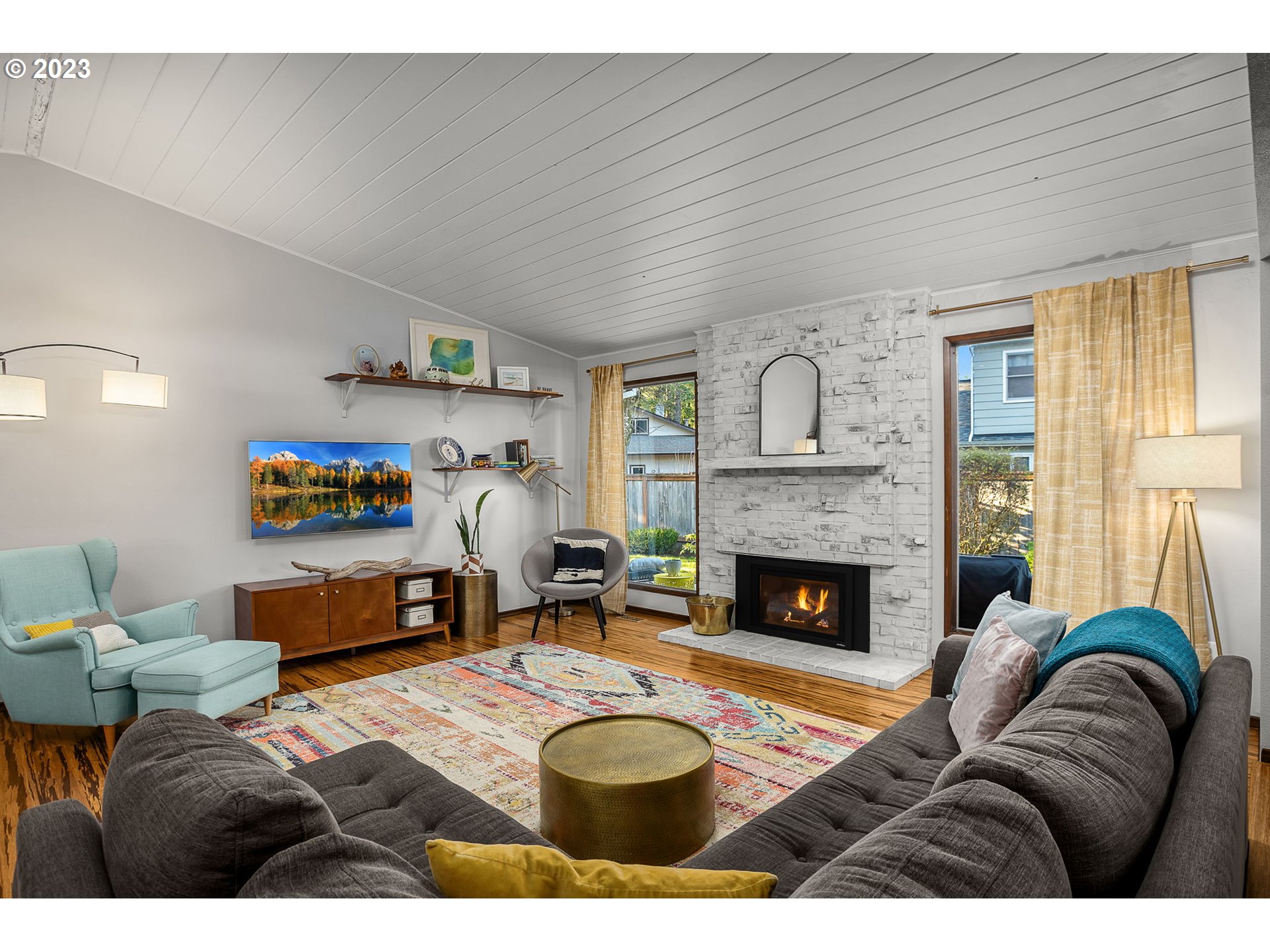 14155 Southwest Hart Road Beaverton, OR 97008 - Photo 25 of 30 a living room with furniture a flat screen tv and a fireplace