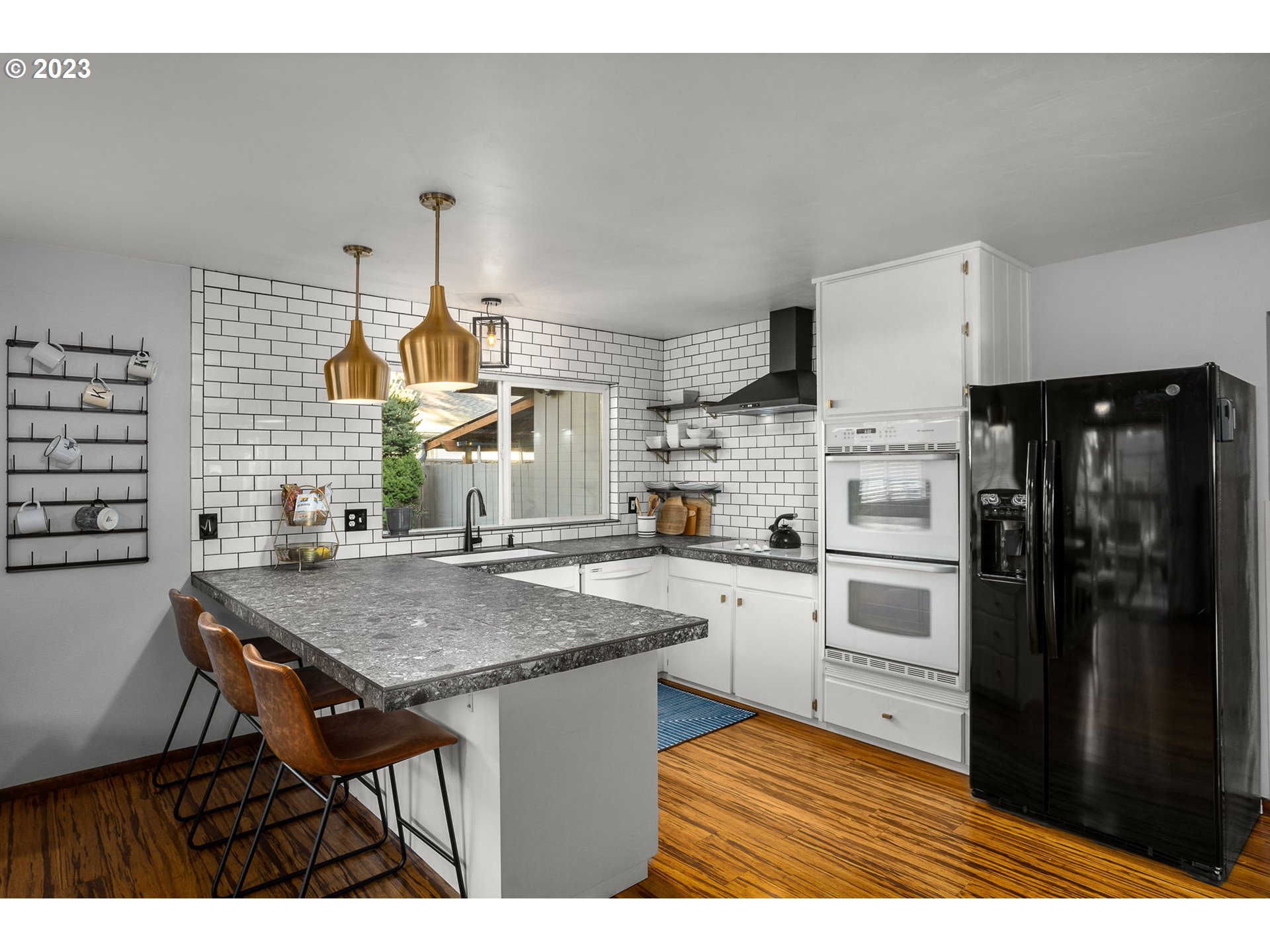 14155 Southwest Hart Road Beaverton, OR 97008 - Photo 4 of 30 a kitchen with a table chairs refrigerator and cabinets