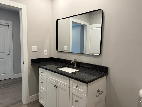 a white toilet sitting next to a bathroom sink