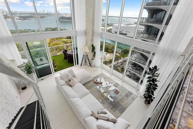 a view of living room with furniture and a floor to ceiling window