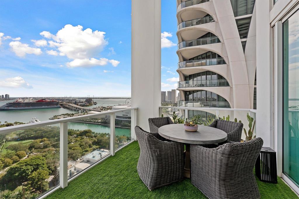 1040 Biscayne Boulevard, Unit 2101 Miami, FL 33132 - Photo 14 of 25 an outdoor sitting area with a table and chairs