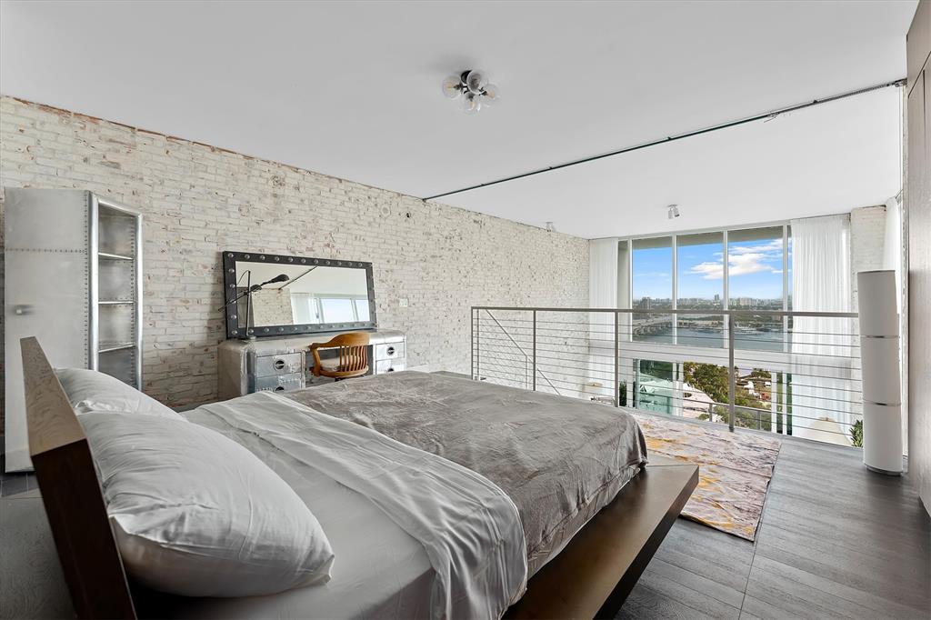 1040 Biscayne Boulevard, Unit 2101 Miami, FL 33132 - Photo 18 of 25 a bedroom with a large bed and a large window
