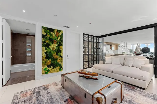 a living room with furniture and a potted plant