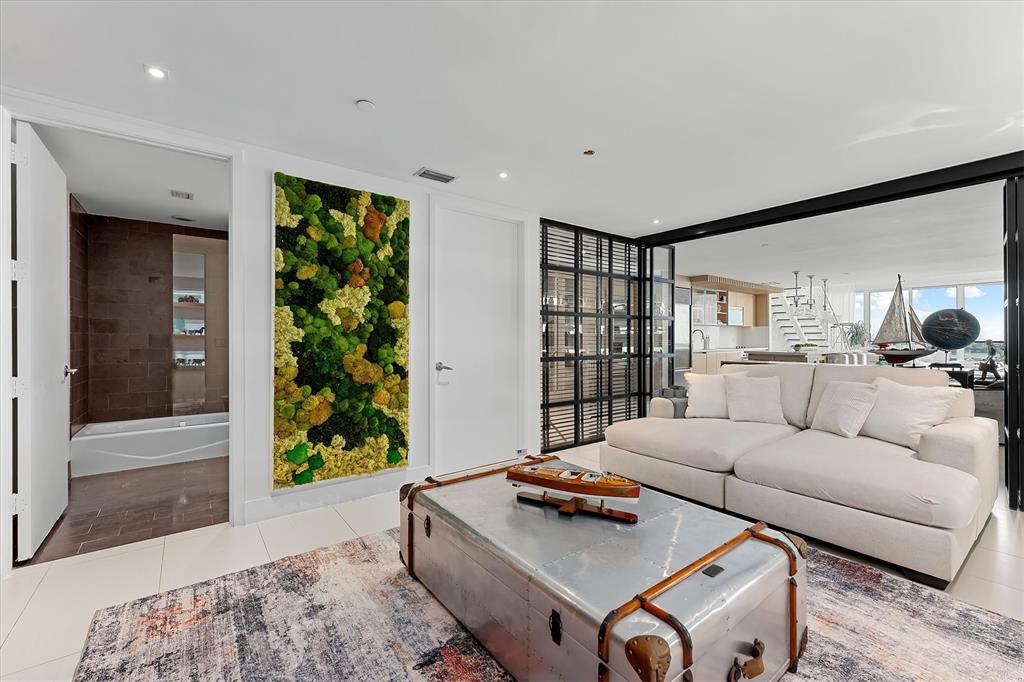 1040 Biscayne Boulevard, Unit 2101 Miami, FL 33132 - Photo 21 of 25 a living room with furniture and a potted plant