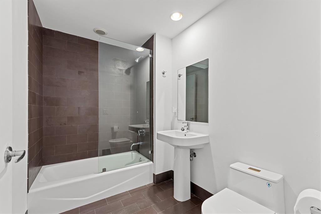 1040 Biscayne Boulevard, Unit 2101 Miami, FL 33132 - Photo 22 of 25 a bathroom with a sink a toilet and shower