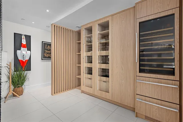 a view of front door with potted plants