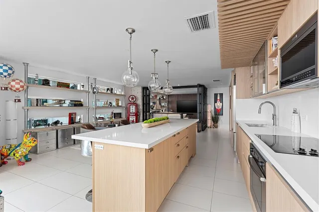 a utility room with a sink a stove and wooden cabinets
