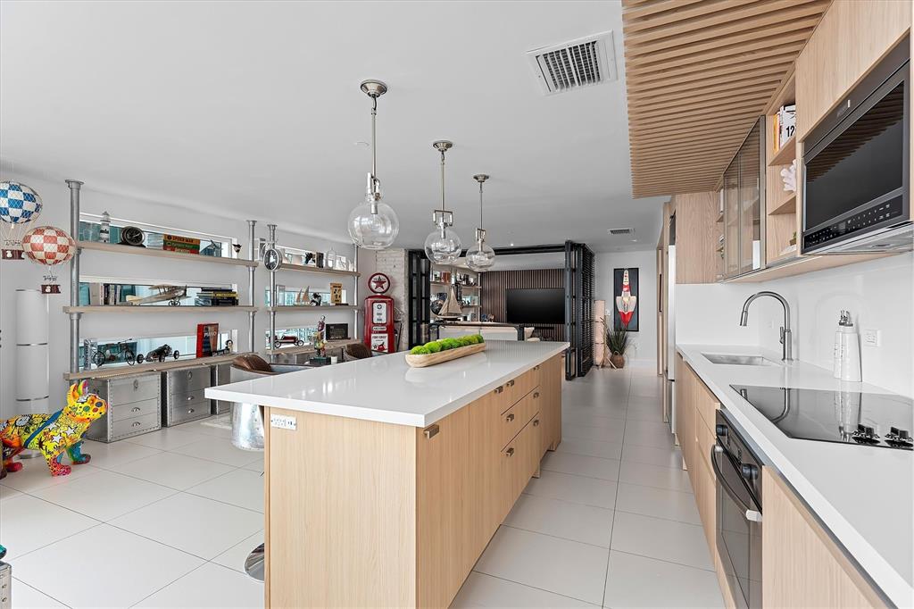 1040 Biscayne Boulevard, Unit 2101 Miami, FL 33132 - Photo 9 of 25 a utility room with a sink a stove and wooden cabinets