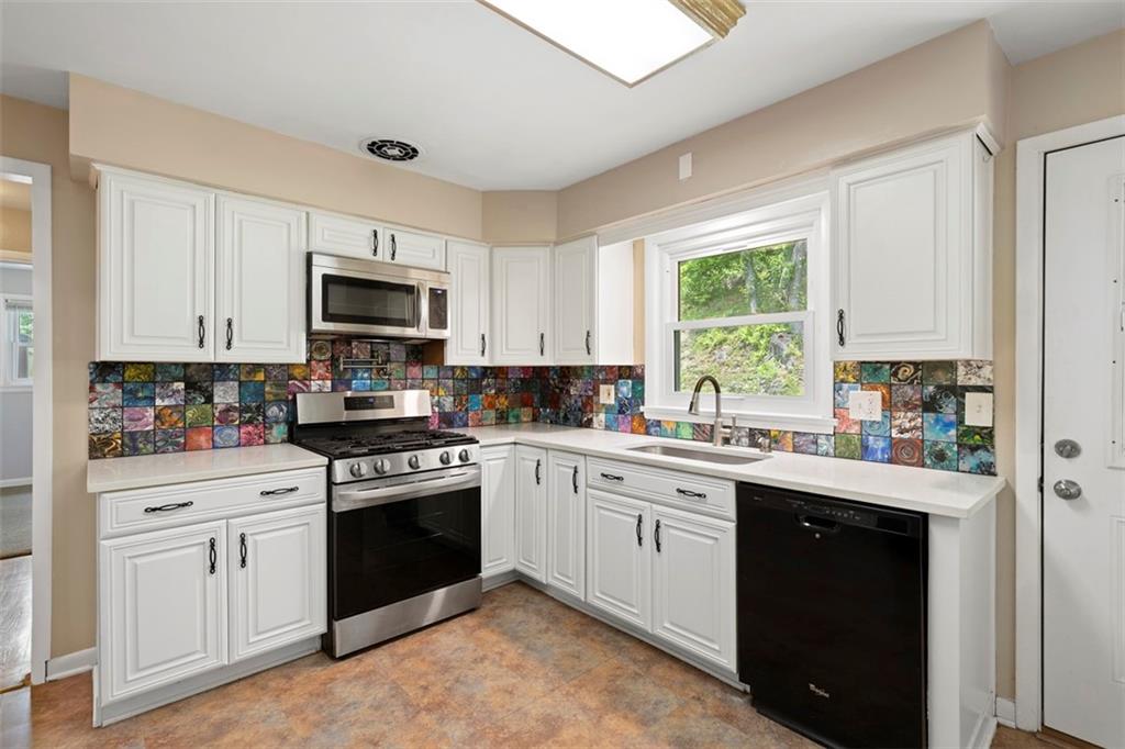 108 W Road Pittsburgh, PA 15209 - Photo 12 of 50 a kitchen with white cabinets sink and appliances