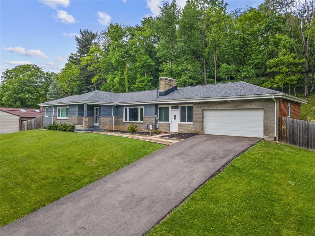 108 W Road Pittsburgh, PA 15209 - Photo 2 of 50 a front view of a house with a yard and trees