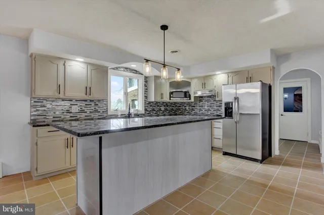 a sink with a granite countertop sink and a window