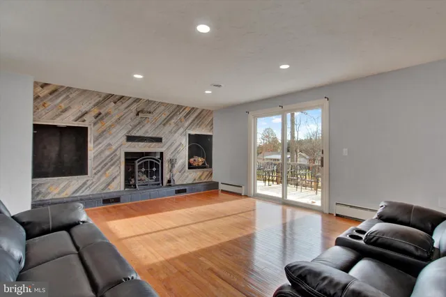 a living room with furniture and kitchen view